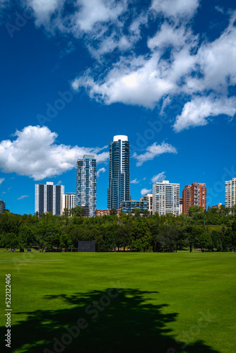 Edmonton cityscape with dramatic clouds over Victoria Park's green in the Province of Alberta, Canada