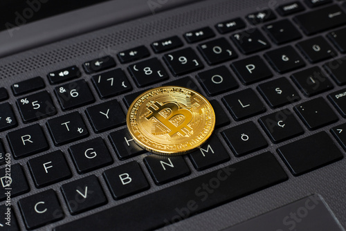 Bitcoin stands on computer keyboard close-up.