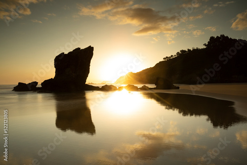 Landscape view of a stunning sunrise at Aguilar Beach in Muros de Nalon, Asturian coast, Spain. Summer and holiday location. photo