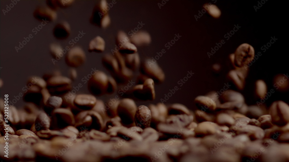 Closeup coffee beans fall on heap. Brown fresh seeds pouring super slow motion Closeup coffee beans fall on heap. Brown fresh seeds pouring super slow motion