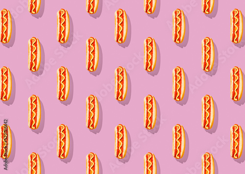 Patter of fresh made hot dogs on pink pastel background