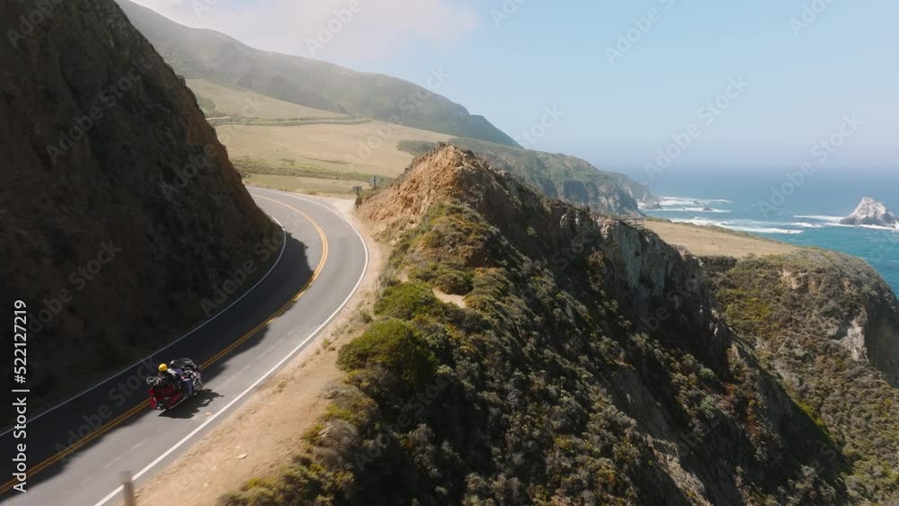 An aerial view of magnificent setting at Bixby Canyon below foggy skyline. Closeup shot above vehicles roadtripping along Californian coastline. High quality 4k footage An aerial view of magnificent setting at Bixby Canyon below foggy skyline. Closeup shot above vehicles roadtripping along Californian coastline. High quality 4k footage