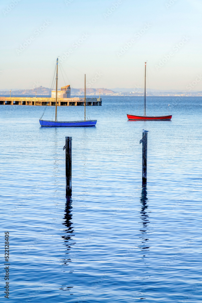 Blue and red boats near the pier at Fisherman's Wharf in San Francisco, CA