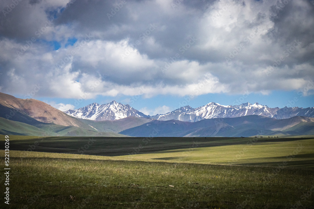 mountain landscape in kyrgyzstan, central asia, clouds, summer pasture