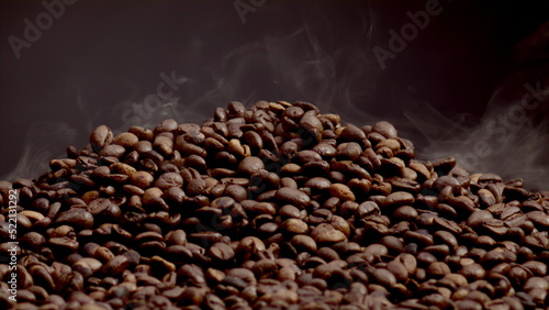 Fragrant smoke coming roasted coffee beans closeup. Steam rising over heap seeds