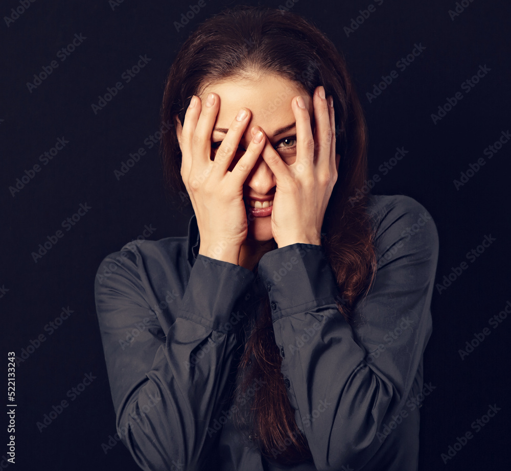 Happy excited fun business beautiful woman covering the face the hand on blue shirt on black background with empty copy space. Closeup Happy excited fun business beautiful woman covering the face the hand on blue shirt on black background with empty copy space. Closeup