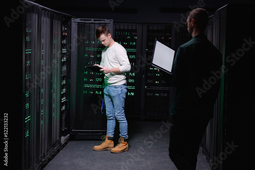 Computer experts working in team to repairing DBMS networking 