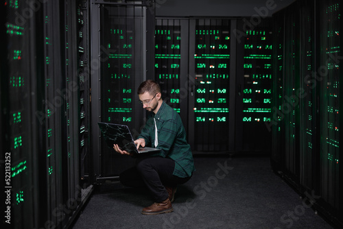 Busy technician making diagnostic of computer software  photo