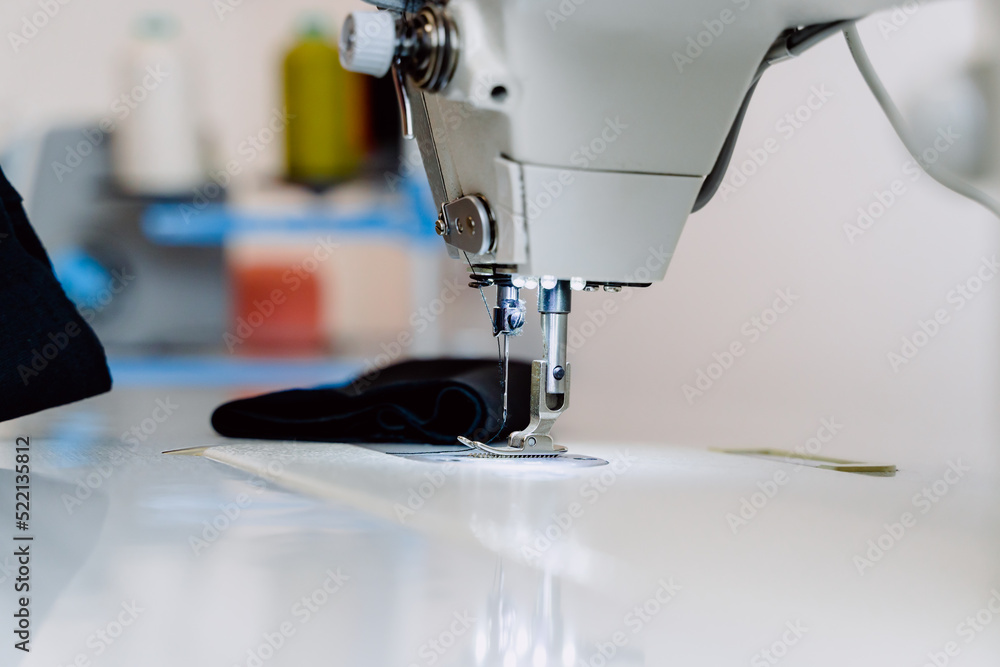 Professional white sewing machine in dressmaker