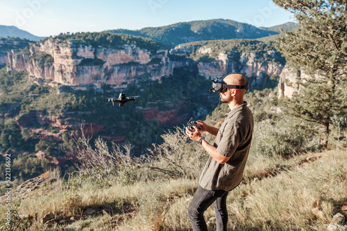 Guy experiencing virtual reality and launching drone photo