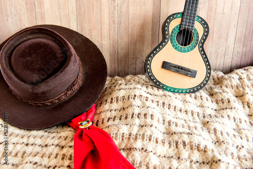 Gaucho tradition, hat, red scarf, poncho and guitar