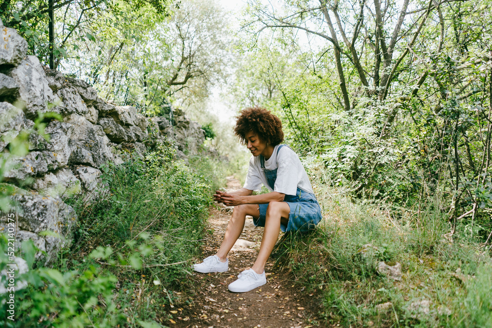 A relaxed woman is sitting in nature A relaxed woman is sitting in nature