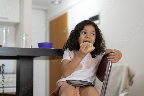 little girl eating Arepa photo