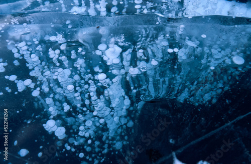 Ice bubbles, methane greenhouse gas trapped beneath frozen Arctic ice photo