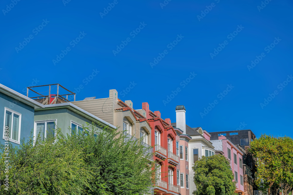 Row of apartments and townhome buildings with trees at the front- San Francisco, CA