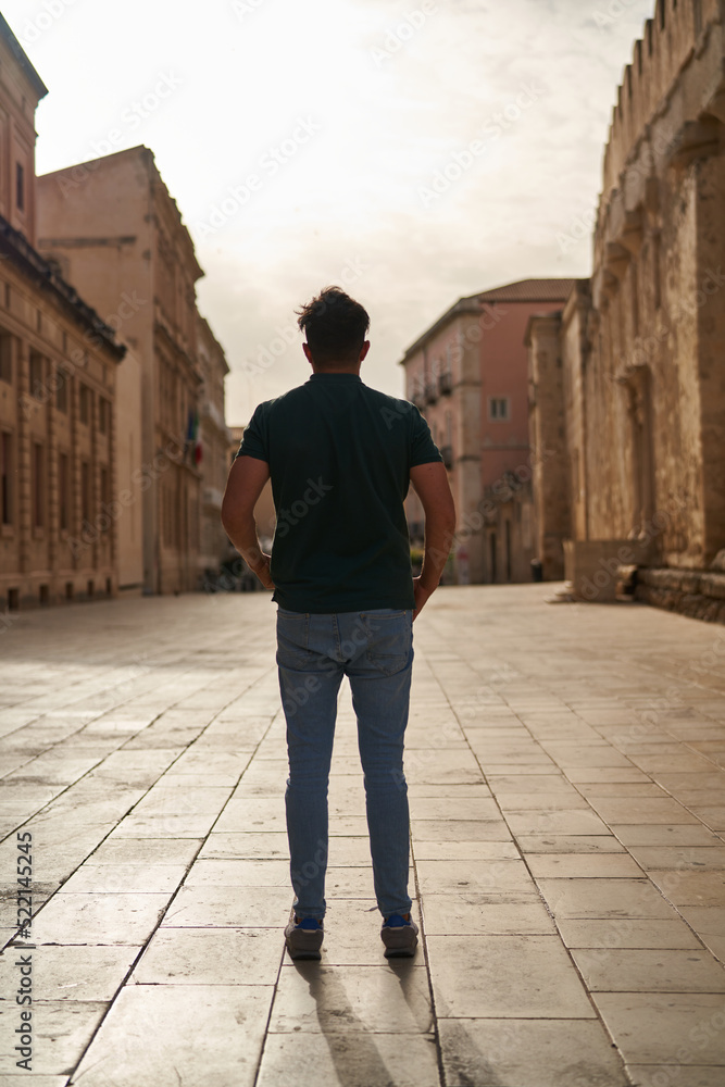 A man's silhouette on an empty historical street A man's silhouette on an empty historical street
