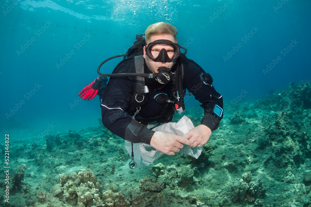Scuba Diver holding Trash Bag Underwater Scuba Diver holding Trash Bag Underwater