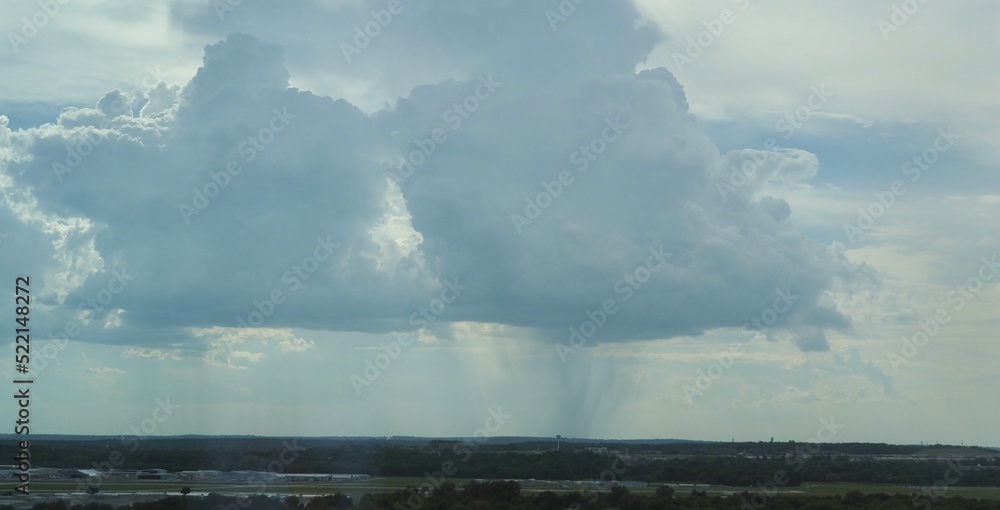 Beginning of Tulsa downburst event on 8-8-22. Light rain falls from a thunderstorm southwest of downtown. Riverside Airport is in the foreground. Downbursts are a hazard to aviation. 