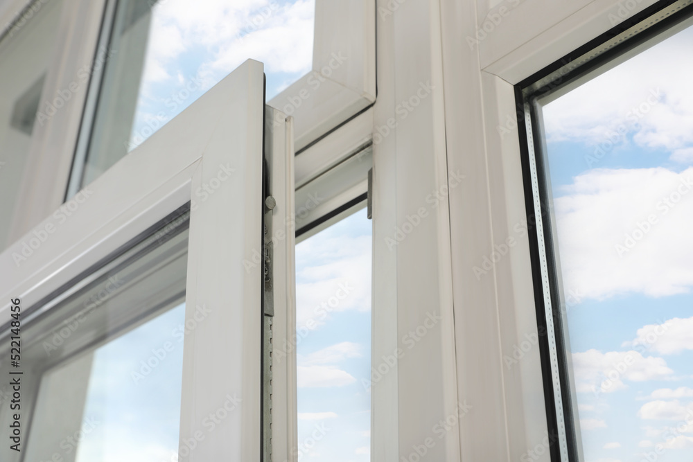Open window with white plastic frame indoors, low angle view Open window with white plastic frame indoors, low angle view