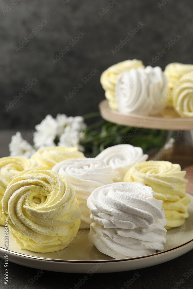 Plate with delicious zephyrs on grey table. Space for text Plate with delicious zephyrs on grey table. Space for text