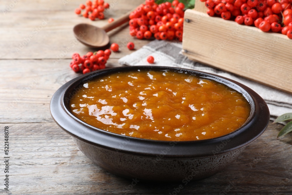 Delicious rowan jam in bowl on wooden table Delicious rowan jam in bowl on wooden table