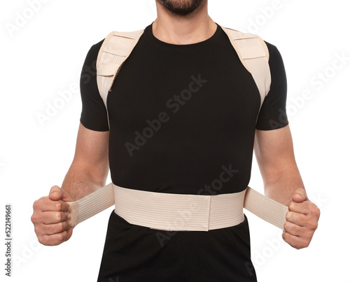 Fotografie Closeup view of man with orthopedic corset on white background