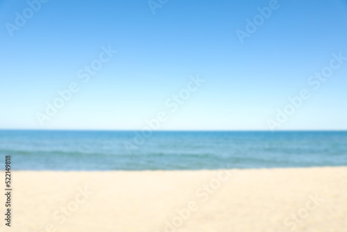 Fototapeta Naklejka Na Ścianę i Meble -  Blurred view of sandy beach near sea