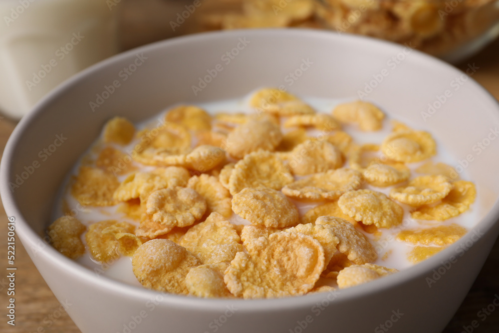 Tasty cornflakes with milk in bowl on table, closeup Tasty cornflakes with milk in bowl on table, closeup