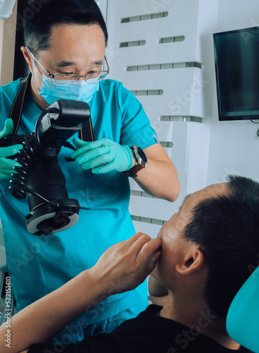 Dentist taking photographyof patient theet for archive photo