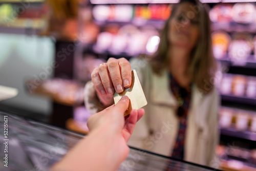 mature woman paying with credit card
