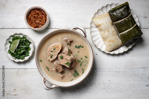 Coto Makasar is Indonesian traditional food from Makasar, Sulawesi, served with Buras. photo