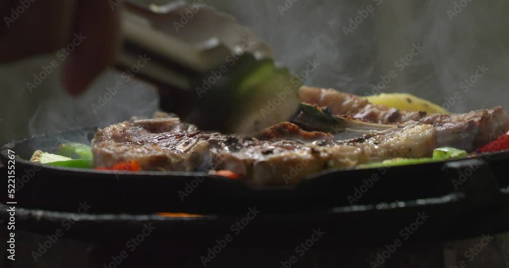 Smoke from roasting delicious lamb steak on black background. Smoke from roasting delicious lamb steak on black background.
