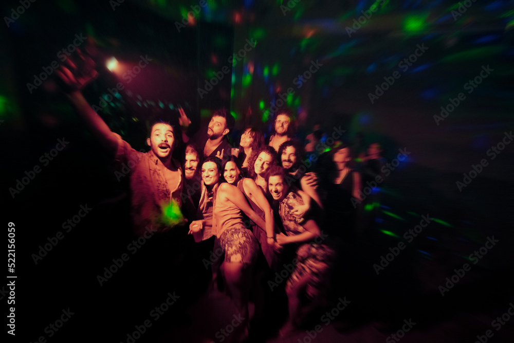 Excited friends at night party posing for the picture Excited friends at night party posing for the picture