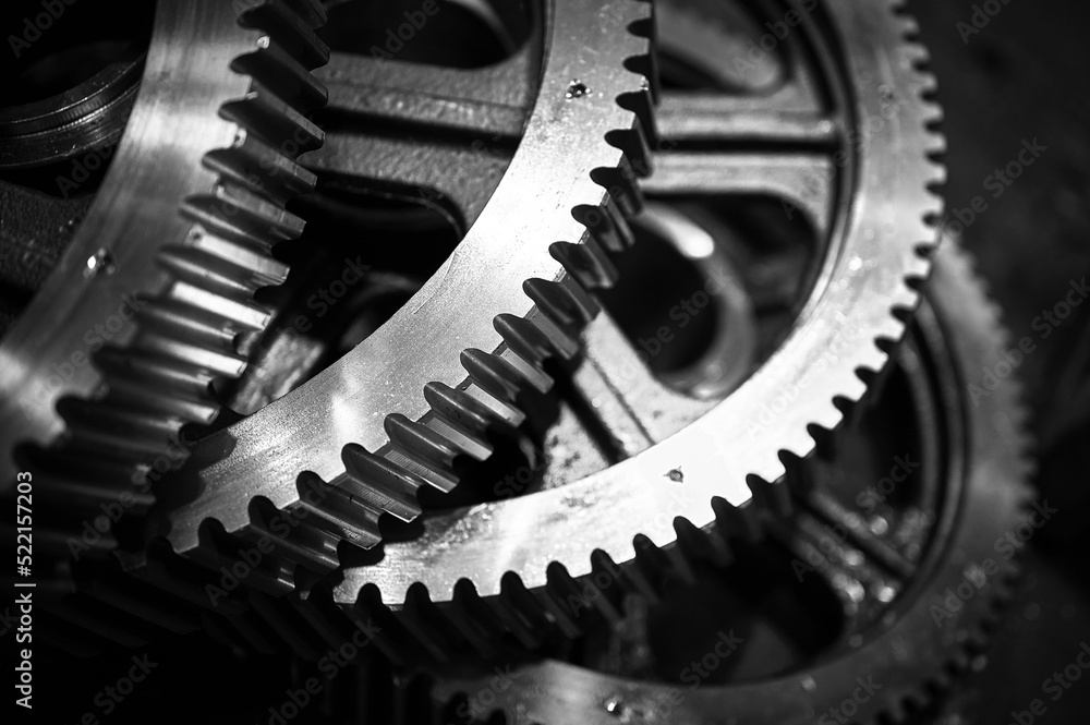 Pile of metal cogwheels for spiral gear drive in warehouse Pile of metal cogwheels for spiral gear drive in warehouse