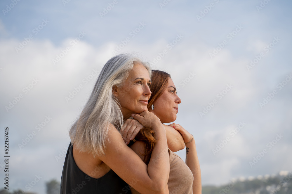 Hugging mother and adult daughter at the beach Hugging mother and adult daughter at the beach