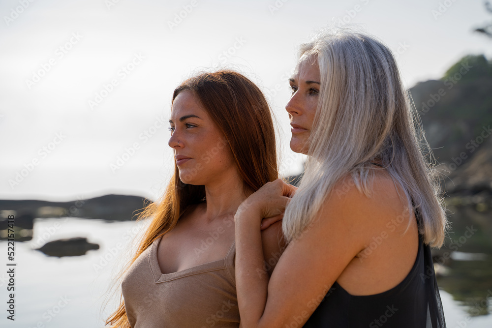 serene mother and adult daughter at the beach serene mother and adult daughter at the beach