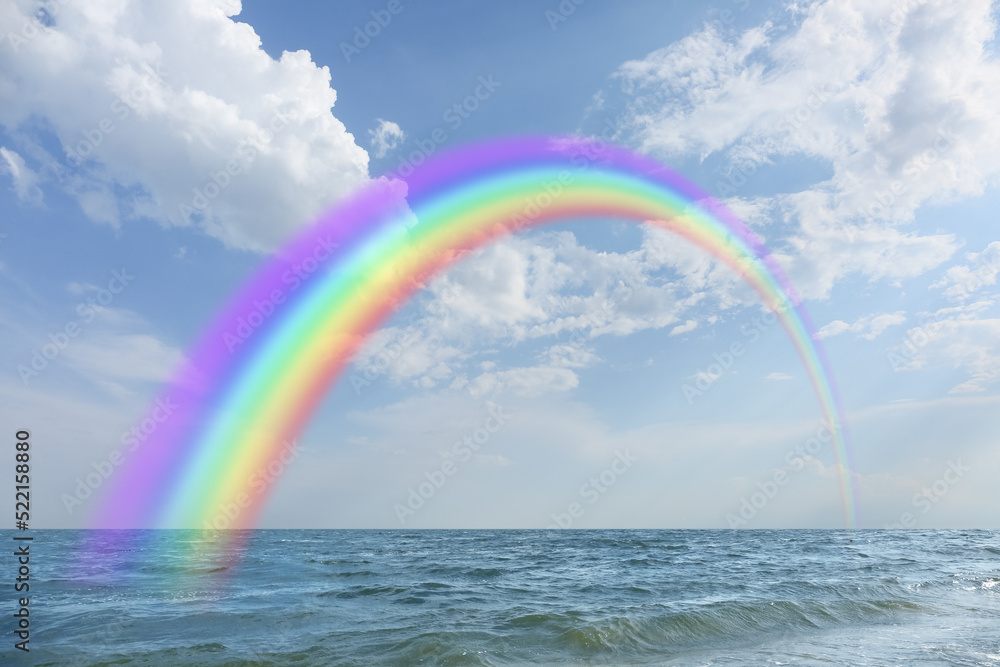 View of sea and beautiful rainbow in sky View of sea and beautiful rainbow in sky