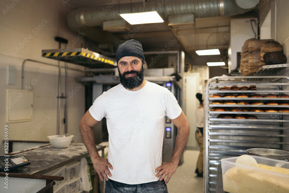 Portrait of cheerful bread maker in the bakehouse Portrait of cheerful bread maker in the bakehouse