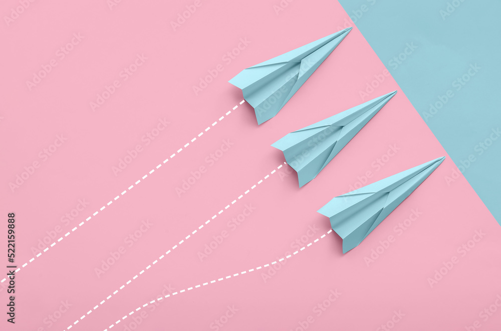 Fototapeta premium Paper planes on color background, top view