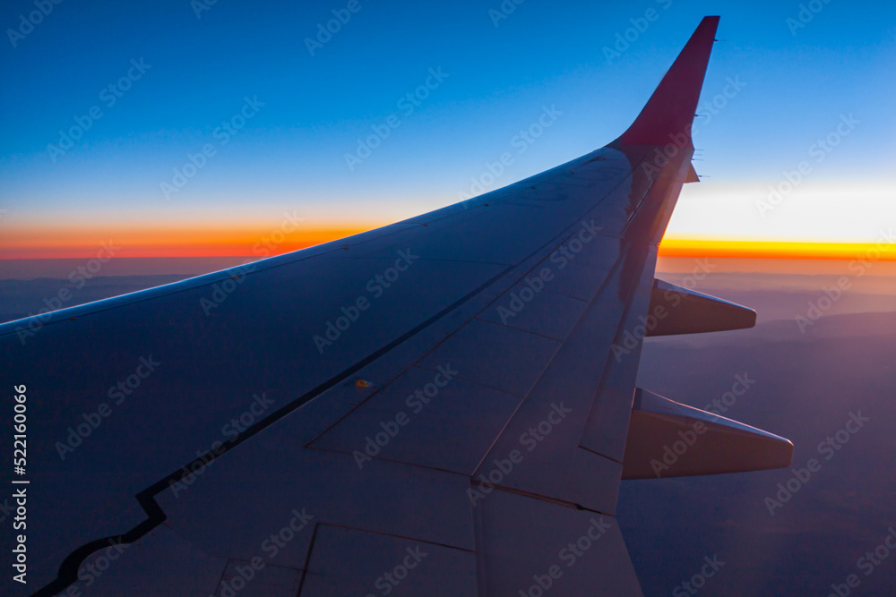 Beautiful Sunrise View from Inside Window Of A Flying Aircraft. Color Gradient From Blue and Orange To Red and Purple. Beautiful Sunrise View from Inside Window Of A Flying Aircraft. Color Gradient From Blue and Orange To Red and Purple.