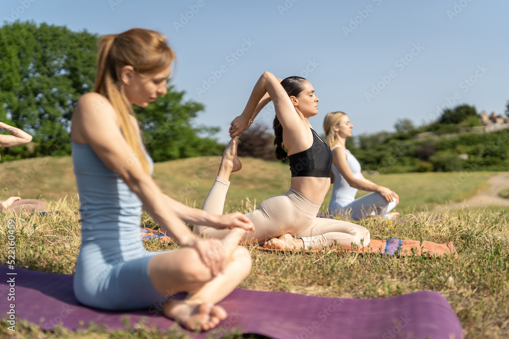 Group of young sporty women practicing yoga lesson Group of young sporty women practicing yoga lesson