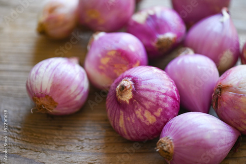 Shallots or red onion  purple shallots on wooden background   fresh shallot for medicinal products or herbs and spices Thai food made from this raw shallot