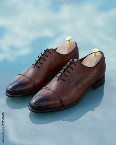 Beautiful leather men's shoes on a blue background photo