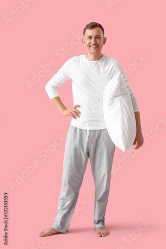 Young man with pillow smili...