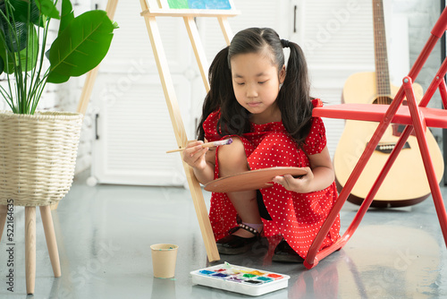 little girl is painting  photo