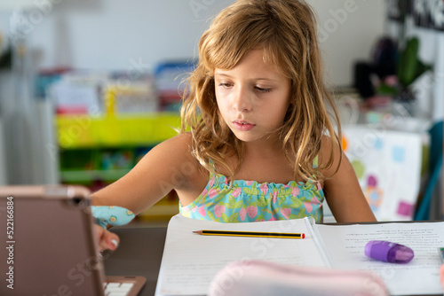 girl doing homework at home photo