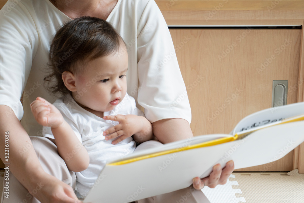 A mother reads a picture book for her child A mother reads a picture book for her child