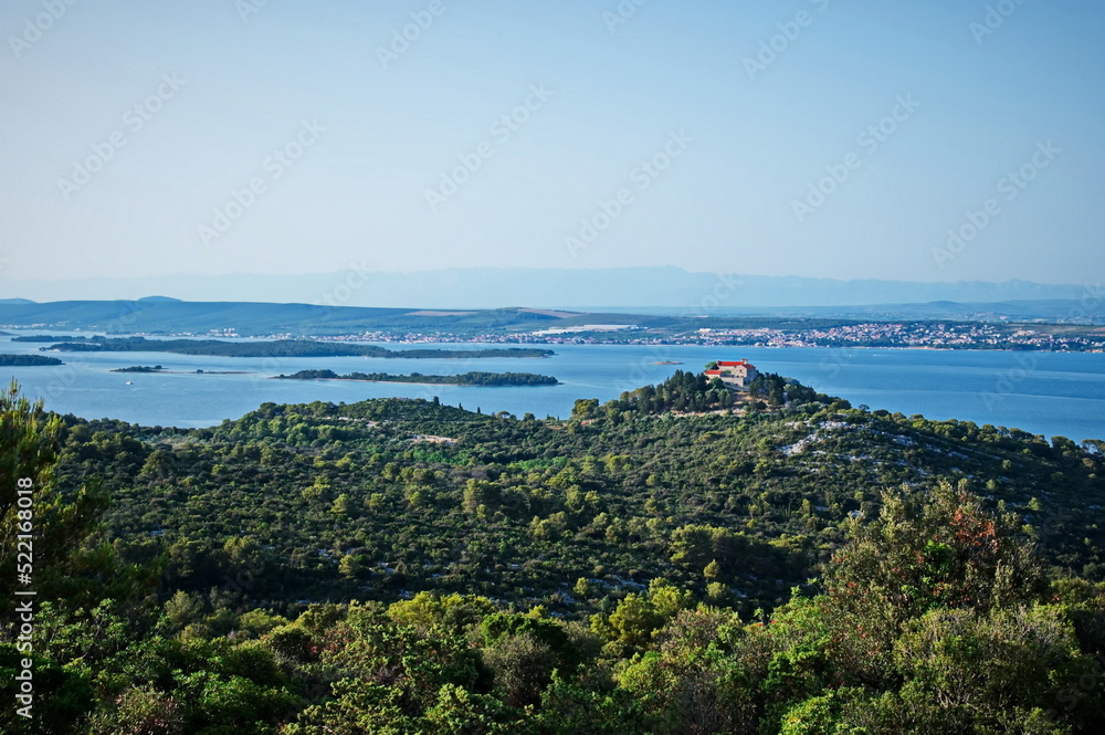 Scenic view of monastery on the hill with sea and islands in background