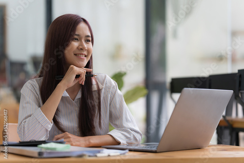 Businesswoman having a video call on laptop while discussion with business partner