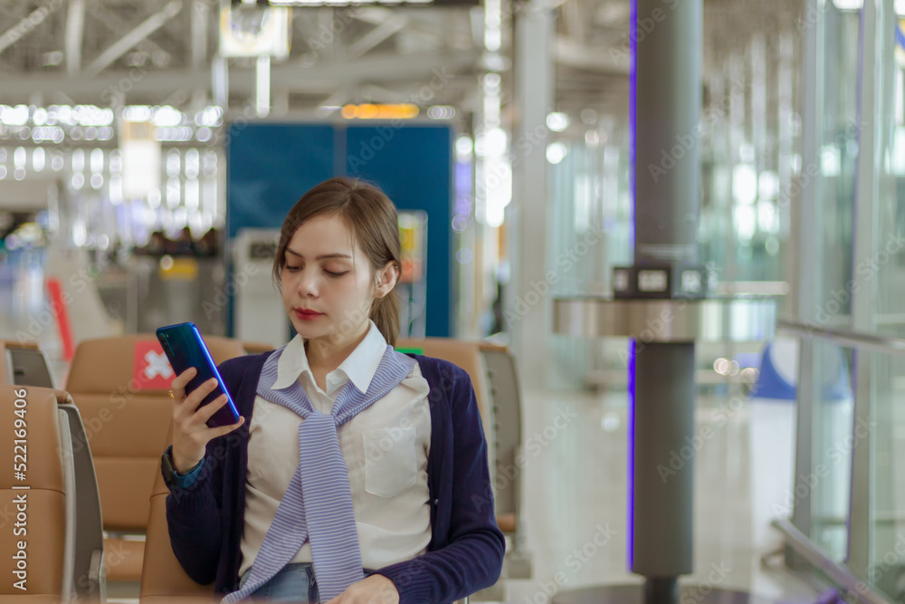 woman use cell phone comunication sitting on the chair in airport woman use cell phone comunication sitting on the chair in airport